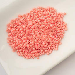 John Bead Cylin 11/0 Cylindrical Seed Beads - Soft Coral Pink Opaque sitting in dish