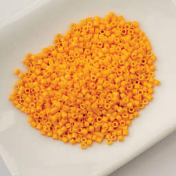 John Bead Cylin 11/0 Cylindrical Seed Beads - Saffron Spice sitting in dish