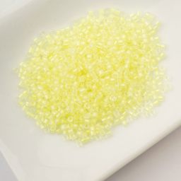 John Bead Cylin 11/0 Glow in the Dark Cylindrical Seed Beads - Yellow, 25g sitting in dish
