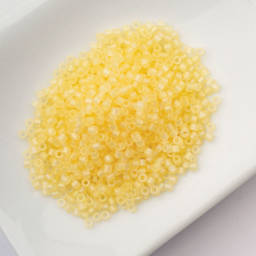 John Bead Cylin 11/0 Matte Macaron Cylindrical Seed Beads - Butter AB sitting in dish