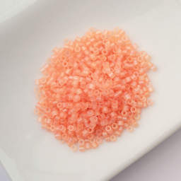 John Bead Cylin 11/0 Matte Macaron Cylindrical Seed Beads - Tangerine AB sitting in dish