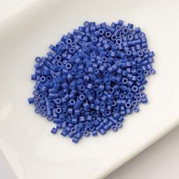 John Bead Cylin 11/0 Cylindrical Seed Beads - Royal Blue Opaque sitting in dish