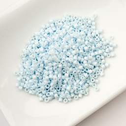 John Bead Cylin 11/0 Cylindrical Seed Beads - Light Blue Sky Opaque sitting in dish