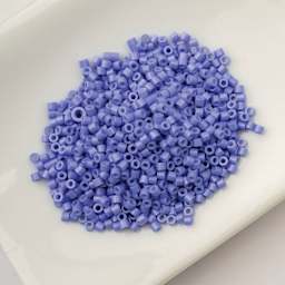 John Bead Cylin 11/0 Cylindrical Seed Beads - Cornflower Blue Opaque sitting in dish