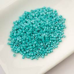John Bead Cylin 11/0 Cylindrical Seed Beads - Turquoise Blue Opaque sitting in dish