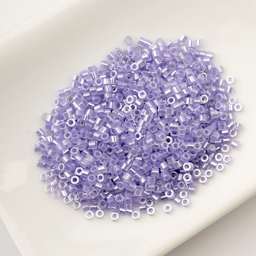 John Bead Cylin 11/0 Ceylon Cylindrical Seed Beads - Crystal Purple Lined, 25g sitting in dish