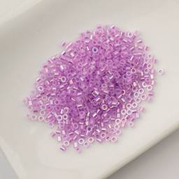 John Bead Cylin 11/0 Glow in the Dark Cylindrical Seed Beads - Purple AB, 25g sitting in dish
