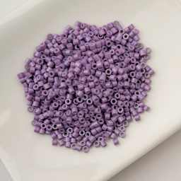 John Bead Cylin 11/0 Cylindrical Seed Beads - Lavender Opaque sitting in dish