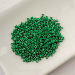 John Bead Cylin 11/0 Cylindrical Seed Beads - Jade Green Opaque sitting in dish