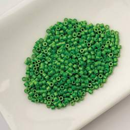 John Bead Cylin 11/0 Cylindrical Seed Beads - Grass Green Opaque sitting in dish