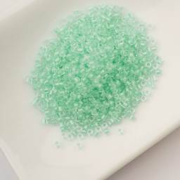 John Bead Cylin 11/0 Glow in the Dark Cylindrical Seed Beads - Green, 25g sitting in dish
