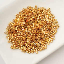 John Bead Cylin 11/0 Cylindrical Seed Beads - Gold AB sitting in dish