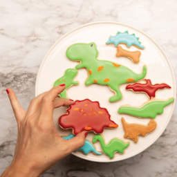 Handstand Kitchen Cookie Cutter Set - Dinosaur, Pkg of 2, cookies cut using dinosaur shapes.