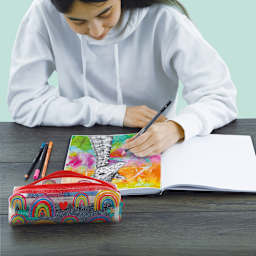 artPOP! Rainbow Pencil Case - Primary, with art supplies on desk