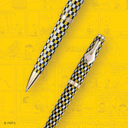 Esterbrook Peanuts 75th Anniversary Ballpoint Pen - Charlie Brown pen over yellow comic background