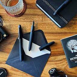 Esterbrook Estie Fountain Pen - Raven Matte Black pens on desk with stationary