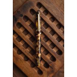 Esterbrook Estie Fountain Pen - Tortoise, resting on wooden coaster