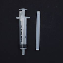 Private Reserve Ink Essentials Long/Magnum Kit 2, a syringe and cartridge against a black background