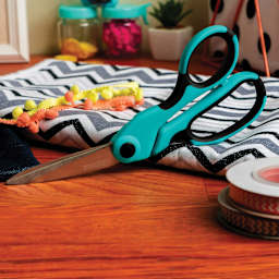 Singer ProSeries Heavy Duty Bent Scissors, on a desk next to sewing materials