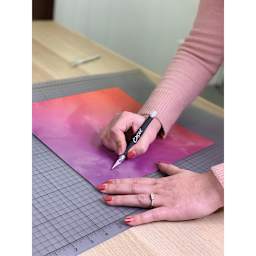 Excel Blades K18 Cushion Grip Knife - Black Knife slicing purple paper