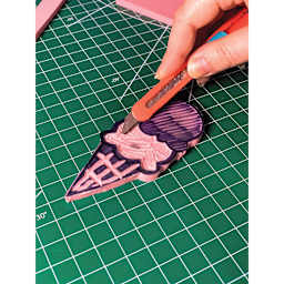 Excel Blades Smart Snap Knife - Pink Knife shown cutting on mat