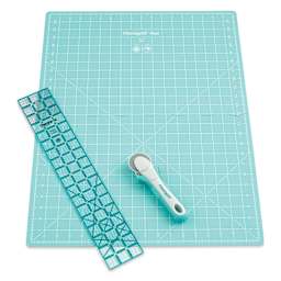 Rotary cutter with large unfolded mat and ruler laid out