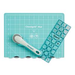 Rotary cutter with small folded mat and ruler laid out