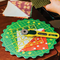 Omnigrid 360 Rotating Cutting Mat - Green/Yellow, 8" - in use on work space (materials not included)