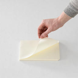 Midori MD Paper Pad - A5, Grid, White, 90 Sheets, sheet being lifted