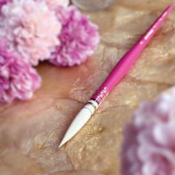 Da Vinci Pretty Pink Casaneo Synthetic Quill Brush - Size 2, close up of brush on tabletop with flowers.