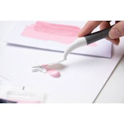 Sizzix Making Tool Effectz Set, spatula in hand spreading paint on a surface