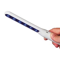 OttLite Rechargeable UVC Disinfecting Wand (Person holding disinfecting wand, Light on)