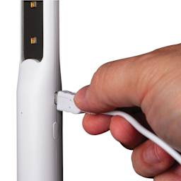 OttLite Rechargeable UVC Disinfecting Wand (Person recharging disinfecting wand)