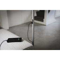 Daylight Slimline 4 LED Floor Lamp - Brushed Steel - demonstrating phone charging capability