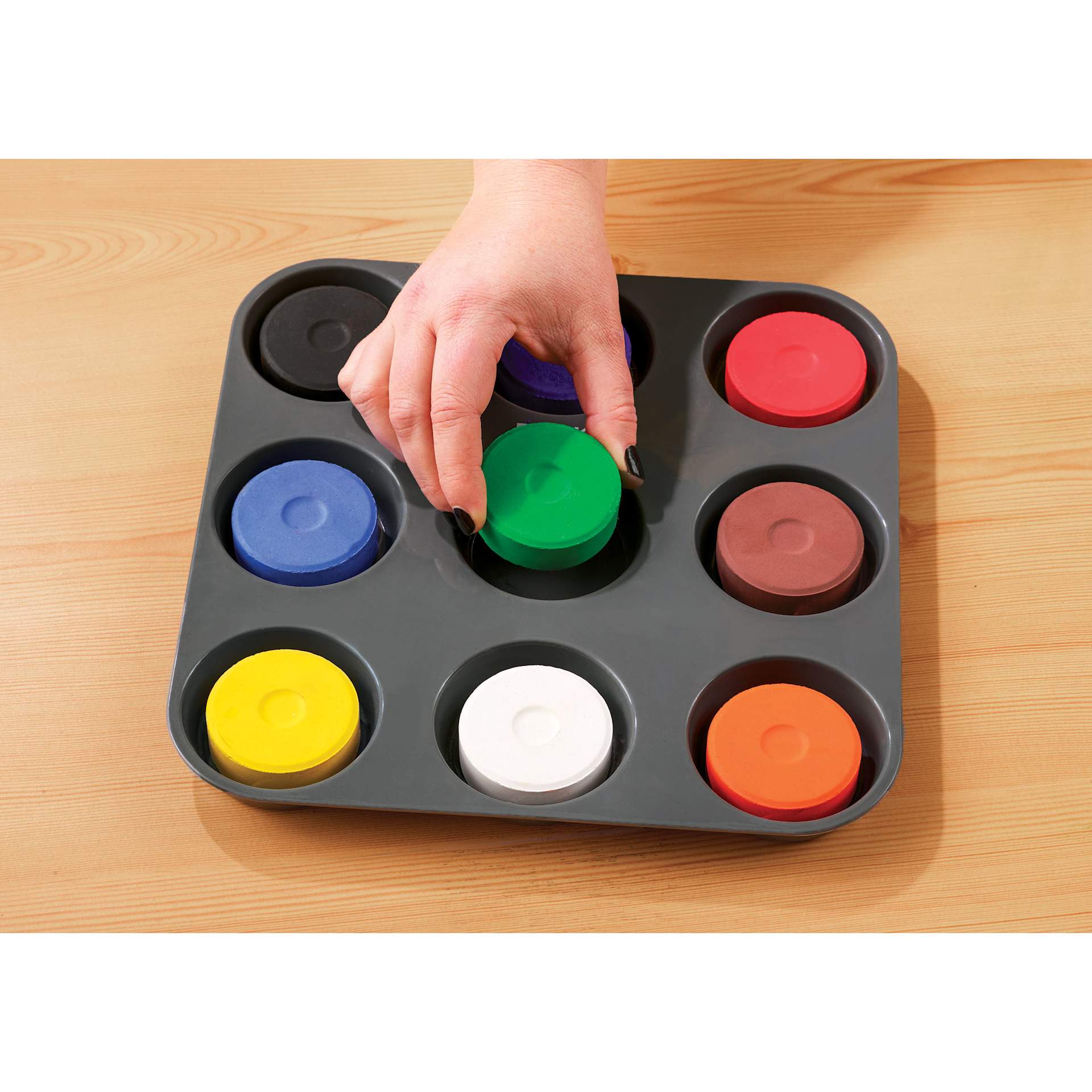 Hand placing refill cake in tray.