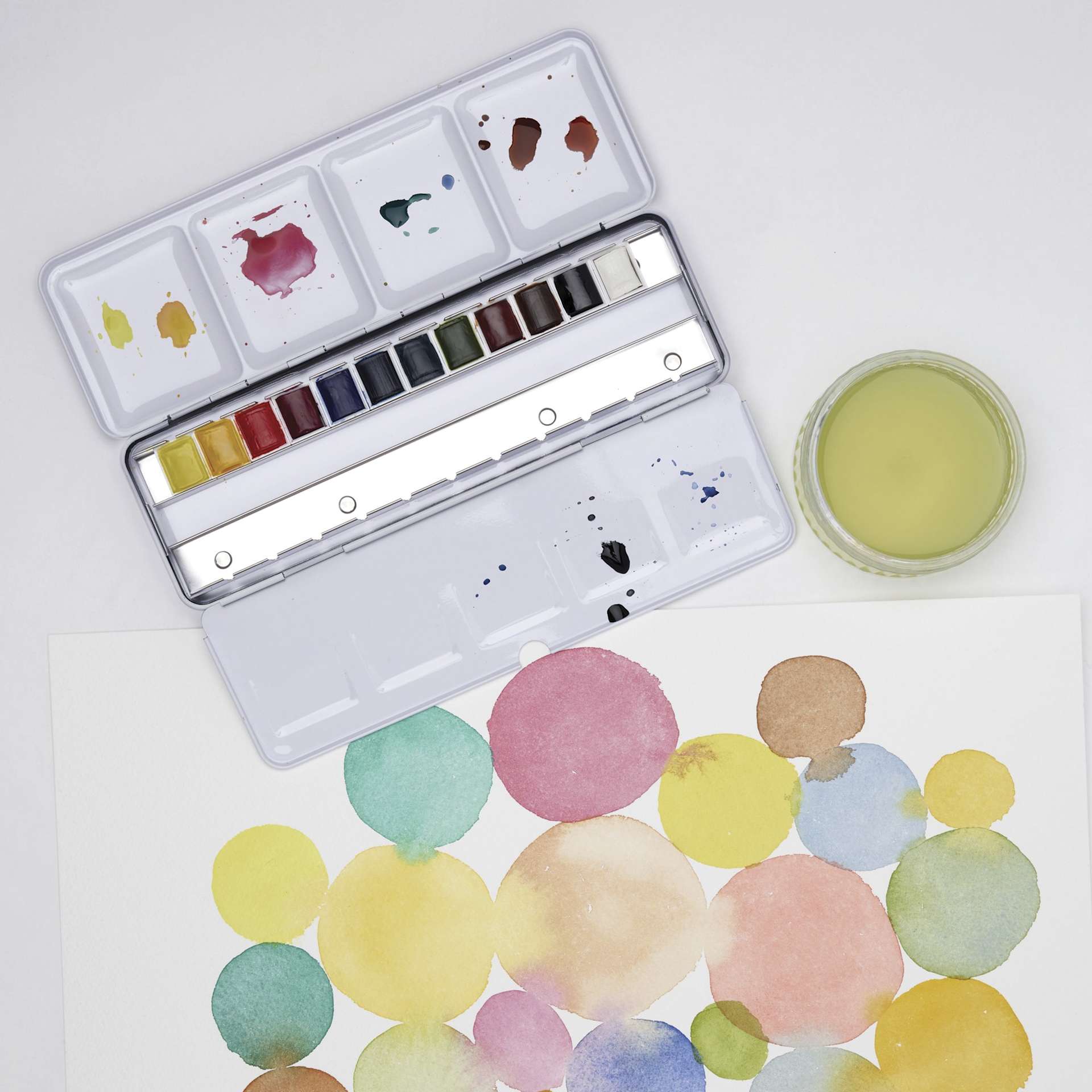 Winsor & Newton Cotman Watercolors - Customizable Travel Set of 12, Assorted Colors, Half Pans, on desk