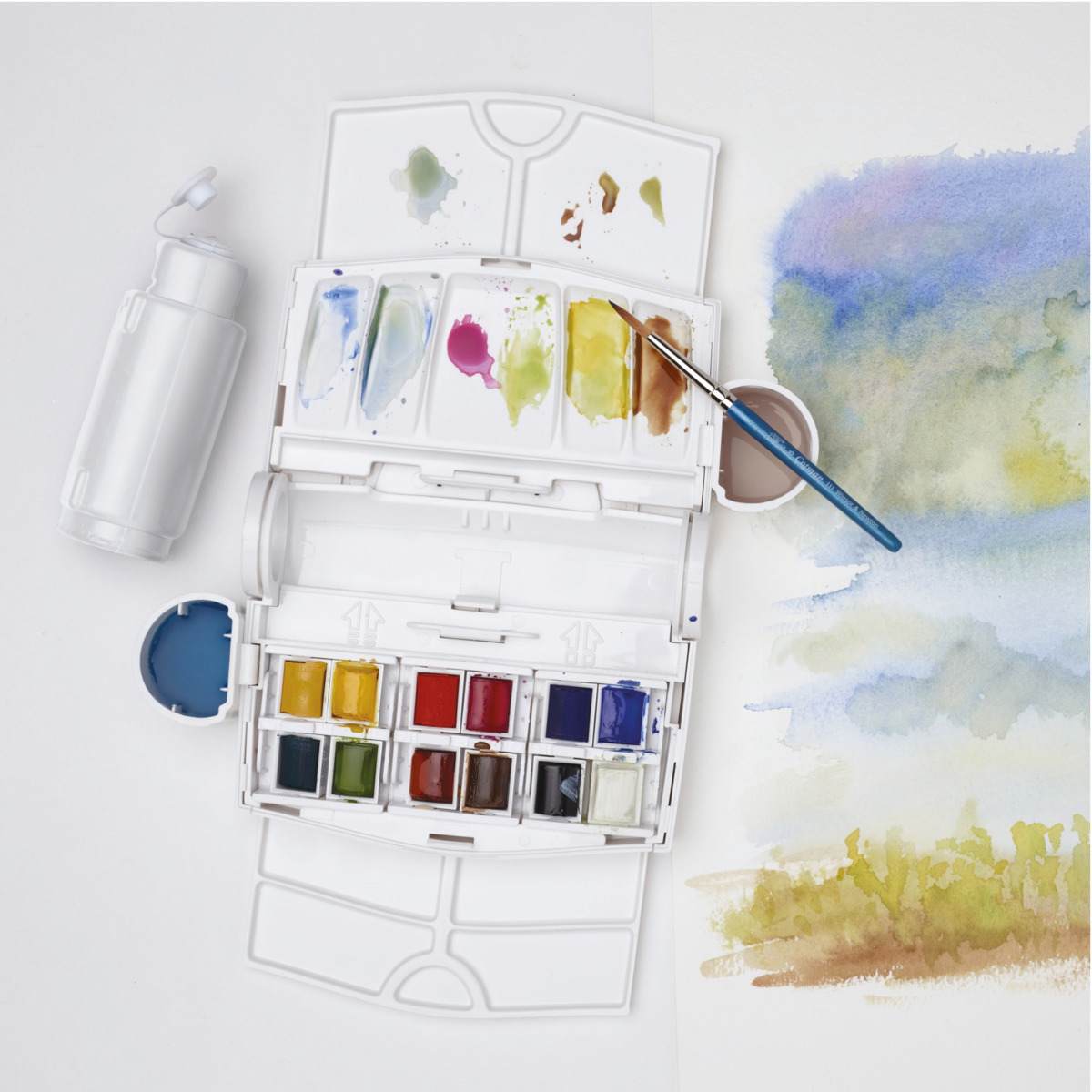 Winsor & Newton Cotman Watercolors - Field Travel Set of 12, Assorted Colors, Half Pans, on desk