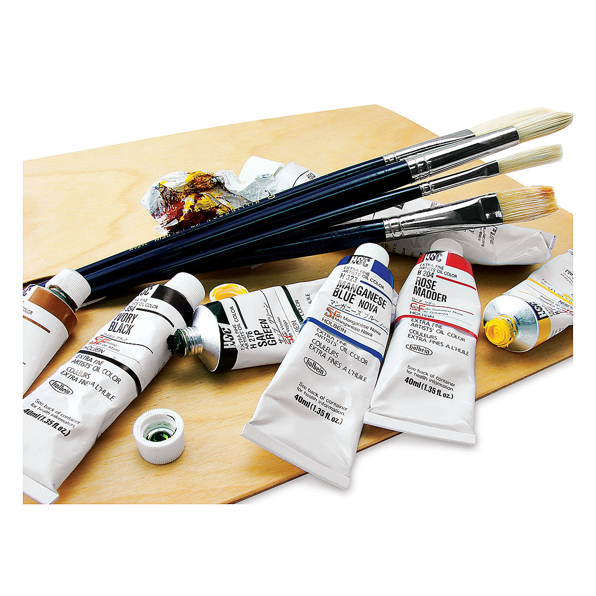 Holbein Artists' Oil Paints - Several tubes of paint, some open, shown on palette with 4 brushes Holbein Artists' Oil Paints - Several tubes of paint, some open, shown on palette with 4 brushes