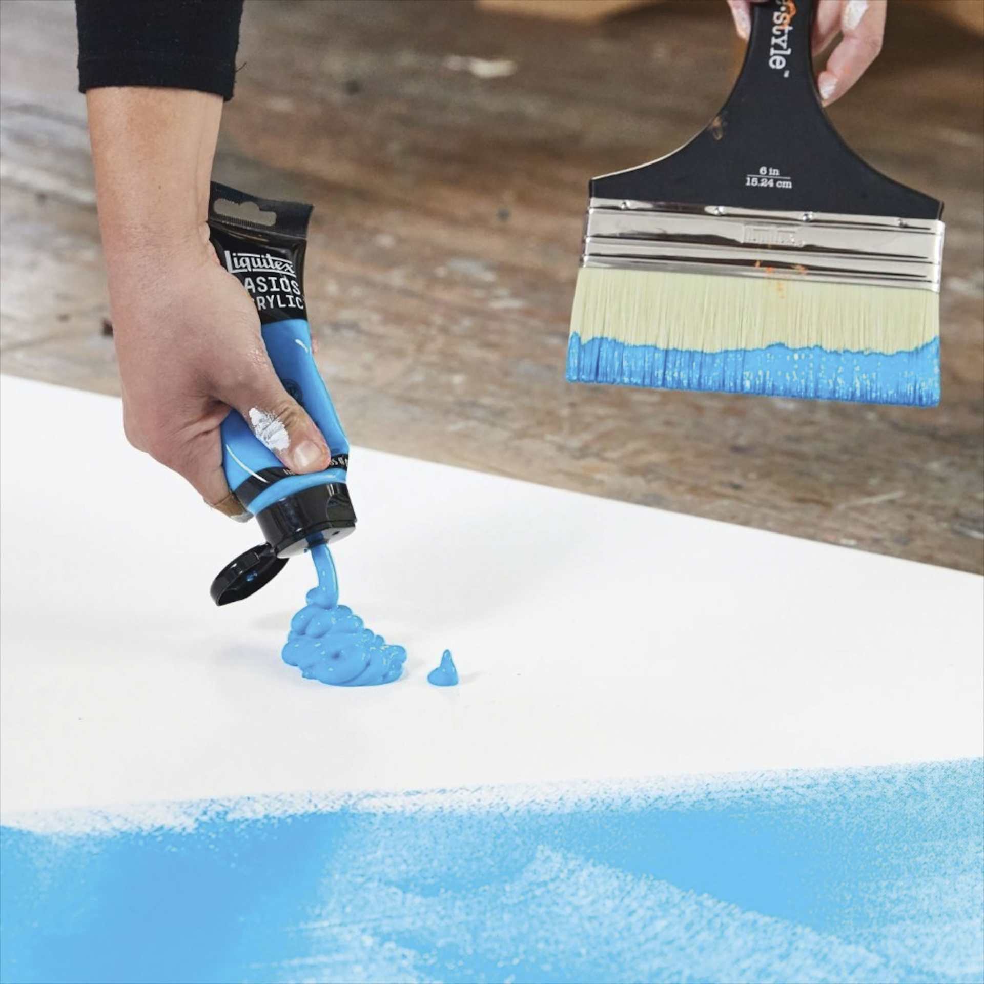 Light Blue paint being applied to a canvas. Light Blue paint being applied to a canvas.