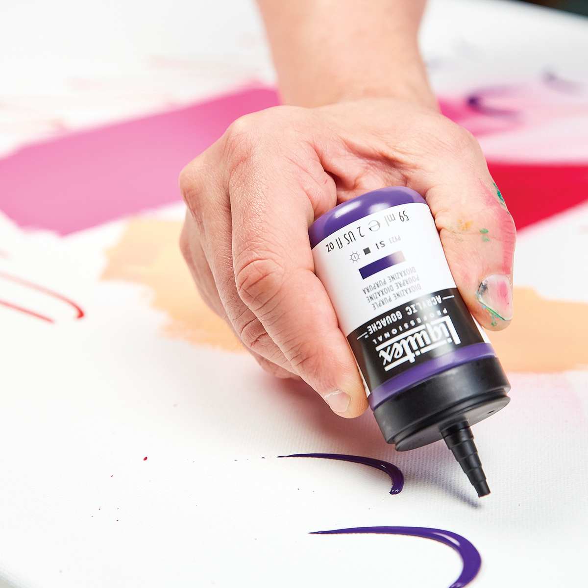 Liquitex Professional Acrylic Gouache Model applying paint with bottle Liquitex Professional Acrylic Gouache Model applying paint with bottle