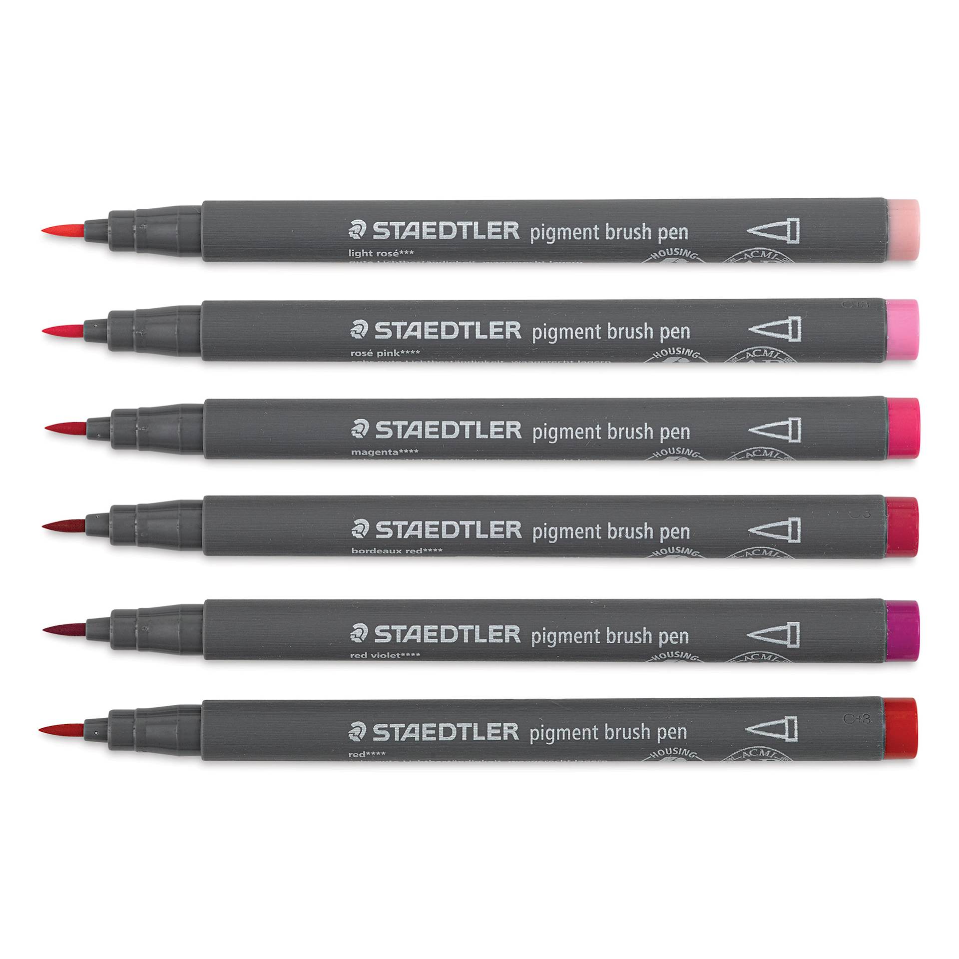 Staedtler Pigment Arts Brush Pens - Reds and Pinks, Set of 6 pens laid out with caps off Staedtler Pigment Arts Brush Pens - Reds and Pinks, Set of 6 pens laid out with caps off