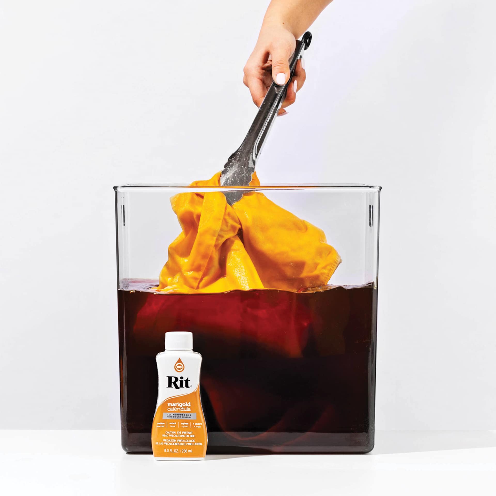 Rit All Purpose Liquid Dye - Marigold, 8 oz submerging fabric in dyed water