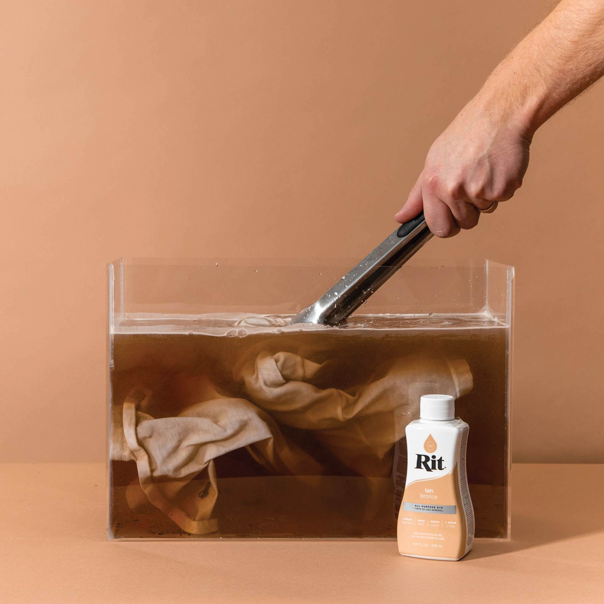 Rit All Purpose Liquid Dye - Tan, 8 oz, submerging fabric in dyed water