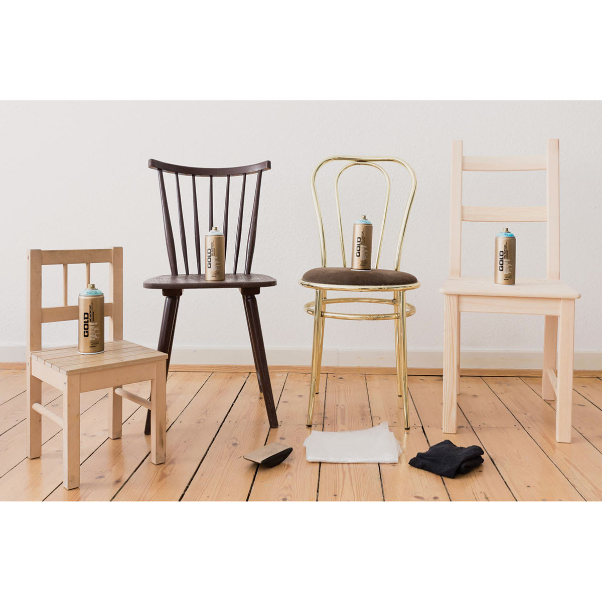 Montana Gold Acrylic Professional Spray Paints - Spray cans on 4 chairs about to be painted blue Montana Gold Acrylic Professional Spray Paints - Spray cans on 4 chairs about to be painted blue