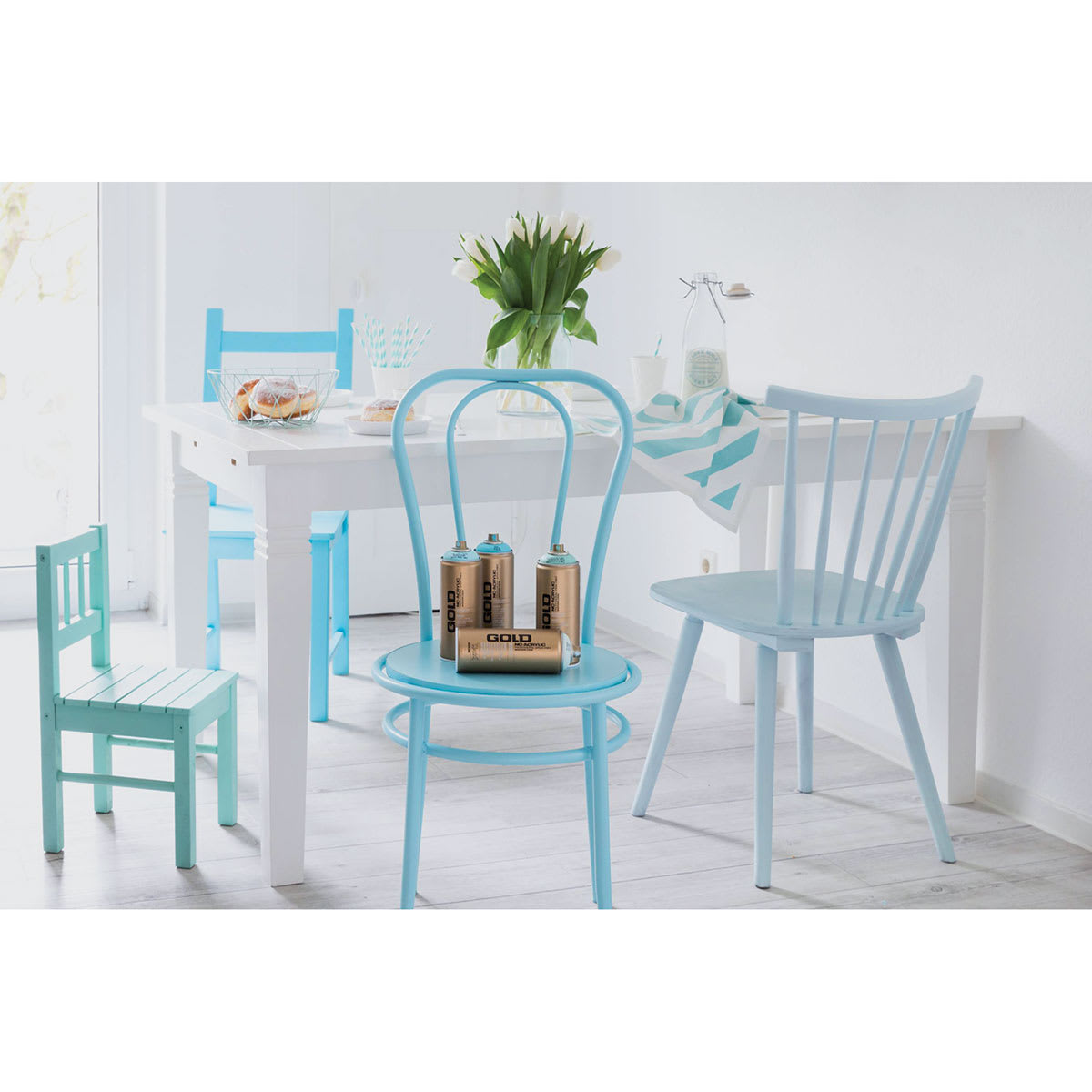 Montana Gold Acrylic Professional Spray Paints - 4 chairs at a table, painted various blue shades Montana Gold Acrylic Professional Spray Paints - 4 chairs at a table, painted various blue shades
