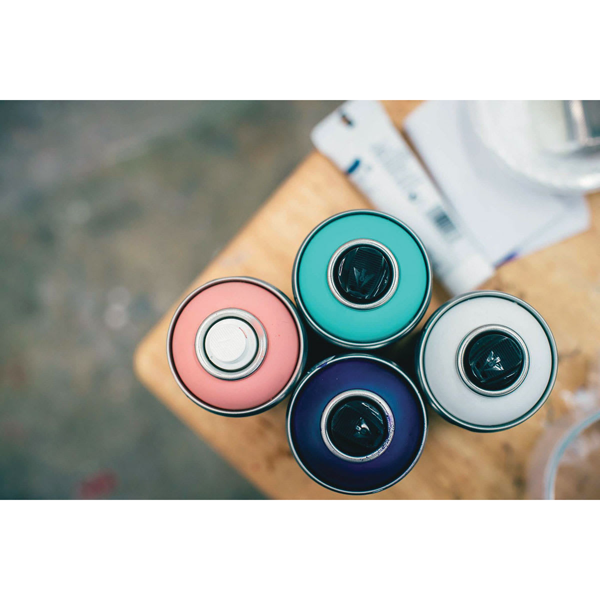 Liquitex Professional Spray Paint -Top view of 4 uncapped spray cans Liquitex Professional Spray Paint -Top view of 4 uncapped spray cans