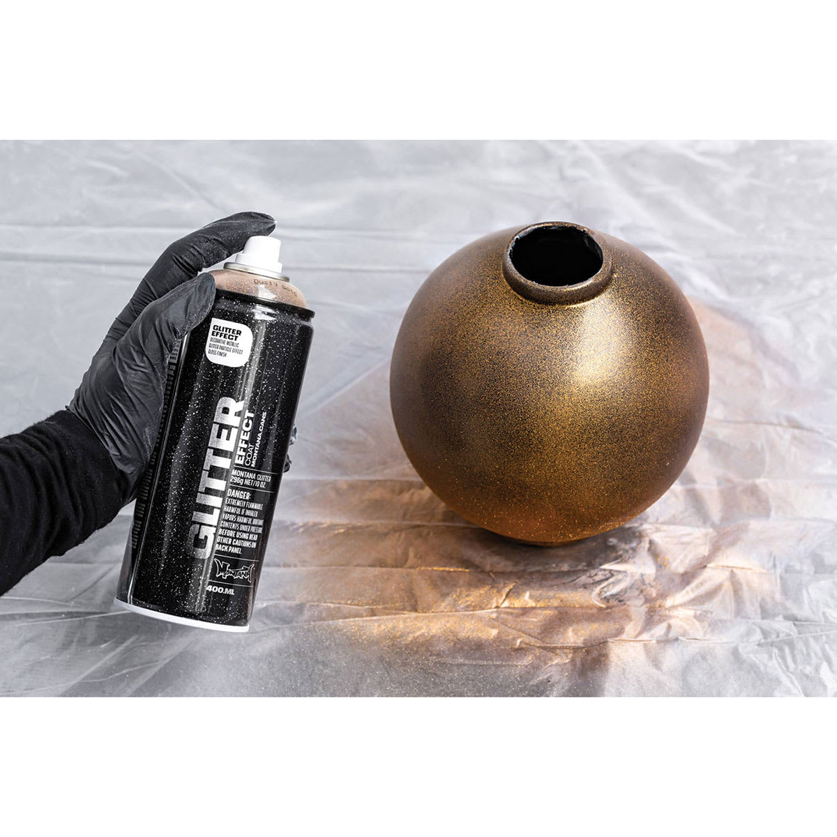 Montana Glitter Effect Spray Paint - Hand shown spray painting round vase gold Montana Glitter Effect Spray Paint - Hand shown spray painting round vase gold
