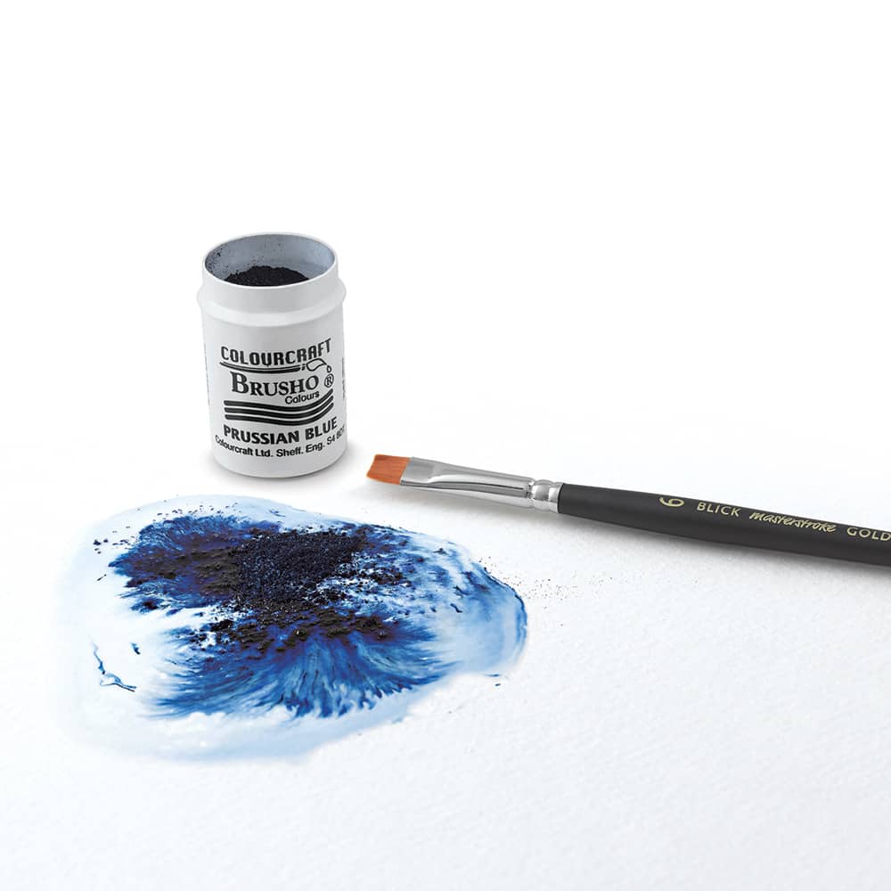 Brusho Crystal Colours - Open Prussian Blue tub with brush next to paper showing swirl of blue