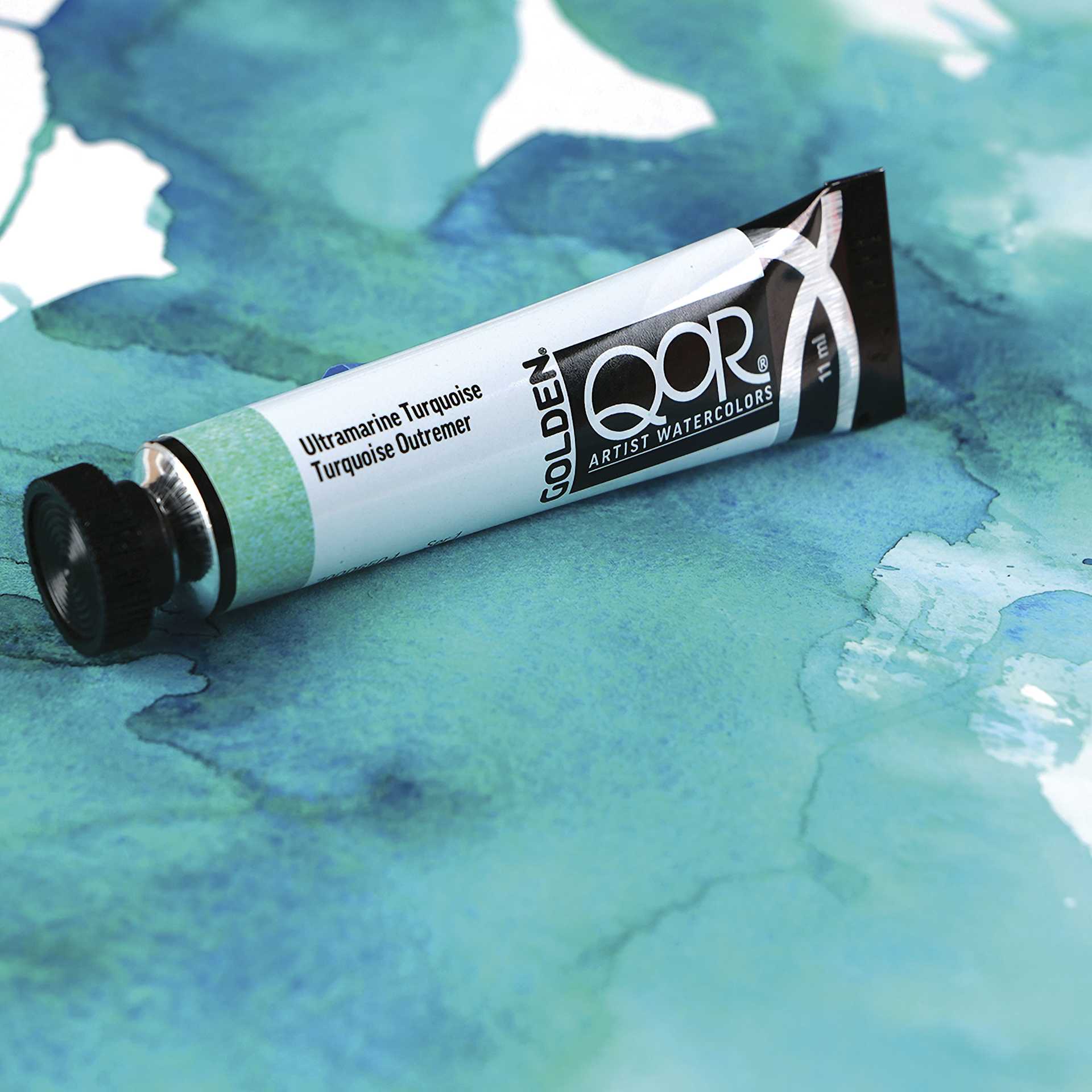 QoR Modern Watercolors Ultramarine Turquoise tube with swatches of the paint