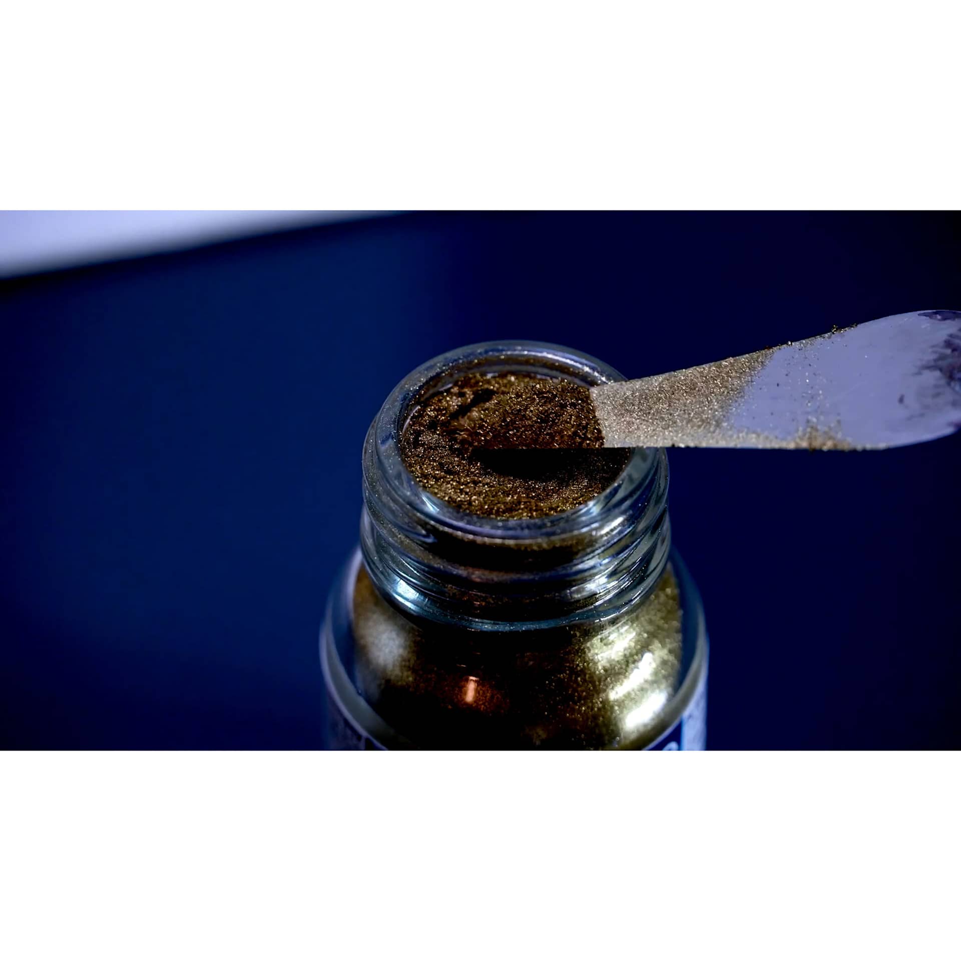 Schmincke Aqua Bronze Powders - being scooped from jar